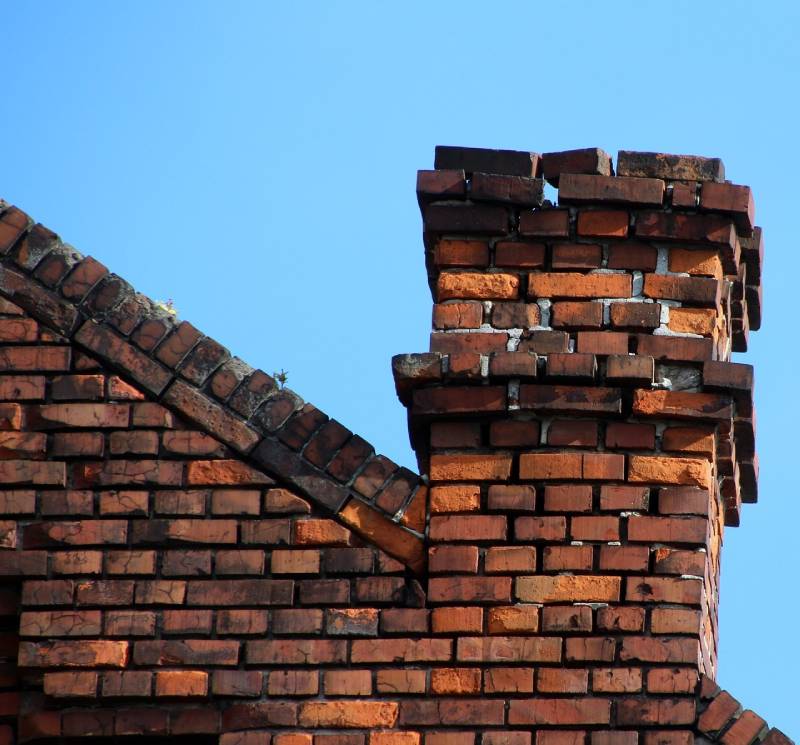 Signs Your Attleboro Home Needs a Chimney Inspection Damaged chimney on an Attleboro home showing cracks and missing mortar